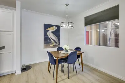 a dining room with a table and blue chairs at Modern Pet-Friendly San Diego Vacation Rental in San Diego