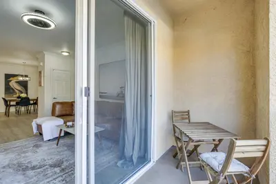 a living room with a table and a glass door at Modern Pet-Friendly San Diego Vacation Rental in San Diego