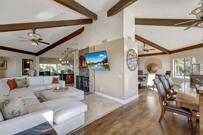 a living room with white furniture and a fireplace at Elevado Hills Family Getaway ~ Pool ~ Games ~ Pkg! in Vista