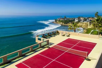 a tennis court sitting on top of the ocean at Celebrity Oceanfront Estate in San Diego