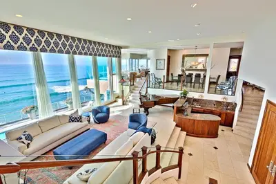 a large living room with a view of the ocean at Celebrity Oceanfront Estate in San Diego