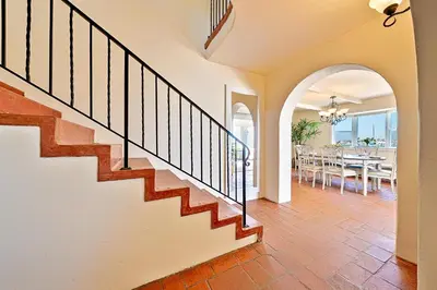a staircase in a house with a dining room at On The Beach Casa in San Diego