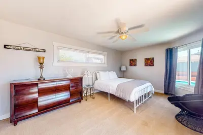 a bedroom with a bed and a ceiling fan at Carthage Corner in San Diego
