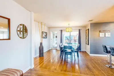 a dining room and living room with a table and chairs at Carthage Corner in San Diego