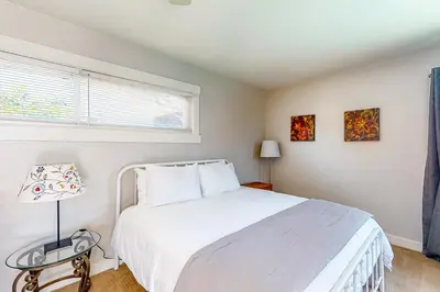 a bedroom with a white bed and a window at Carthage Corner in San Diego