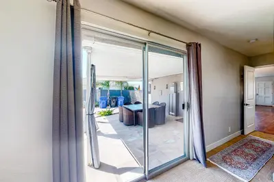 a sliding glass door leading into a living room at Carthage Corner in San Diego
