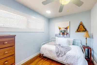 a bedroom with a bed and a ceiling fan at Carthage Corner in San Diego