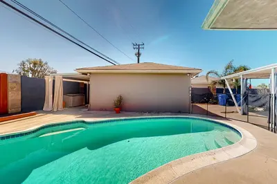 a swimming pool in front of a house at Carthage Corner in San Diego