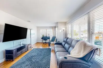 a living room with a couch and a flat screen tv at Carthage Corner in San Diego