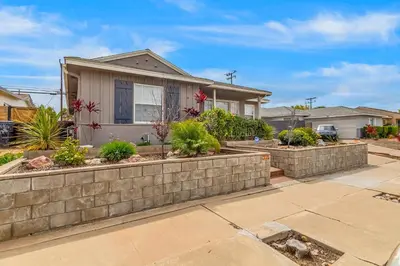 a home with a retaining wall and a yard at Carthage Corner in San Diego