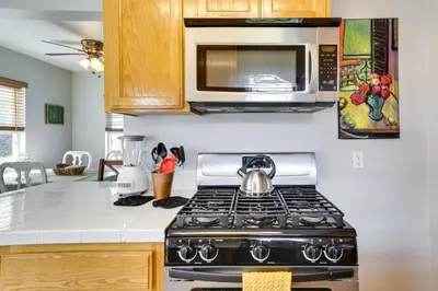 a kitchen with a stove and a microwave at Pet-Friendly San Diego Home with Patio 5 Mi to Dtwn in San Diego