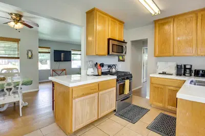 a kitchen with wooden cabinets and a stove top oven at Pet-Friendly San Diego Home with Patio 5 Mi to Dtwn in San Diego
