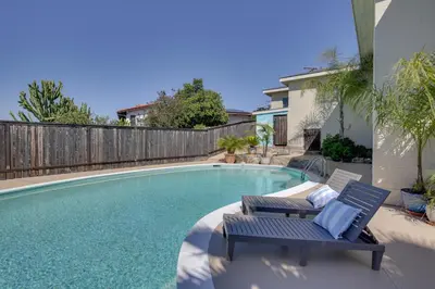 a swimming pool with two lounge chairs next to a house at Charming Spring Valley Retreat with Private Pool! in Spring Valley