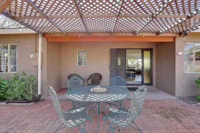 a patio with a table and chairs under a pergola at Charming Spring Valley Retreat with Private Pool! in Spring Valley