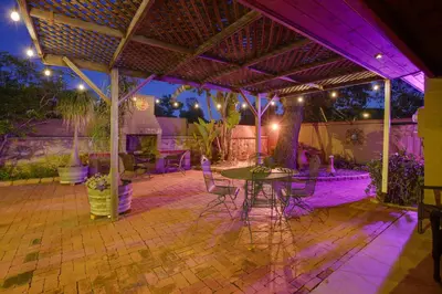 a patio with a table and chairs and purple lights at Charming Spring Valley Retreat with Private Pool! in Spring Valley
