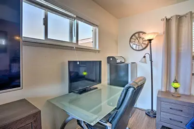a glass desk with a television and a chair at Newport Beach Vacation Rental - Short Walk to Pier in Newport Beach