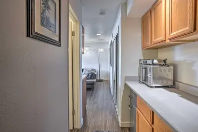 a kitchen with a microwave on a counter and a hallway at Newport Beach Vacation Rental - Short Walk to Pier in Newport Beach