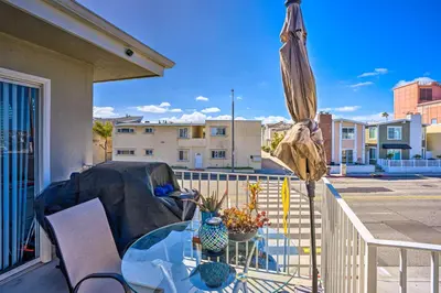 a patio with a glass table and an umbrella at Newport Beach Vacation Rental - Short Walk to Pier in Newport Beach