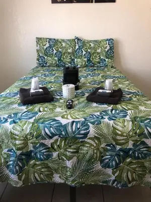 a bed with a colorful bedspread on top of it at Crown Inn & Suites in Spring Valley