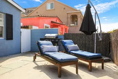 two chairs and an umbrella on a patio at 210 Forty Fourth Street in Newport Beach