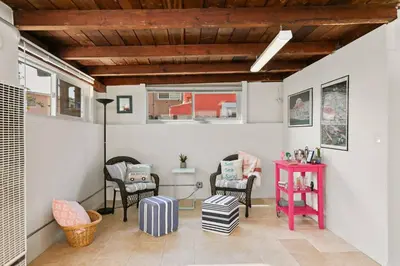 a room with chairs and a table with luggage at 210 Forty Fourth Street in Newport Beach
