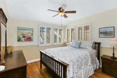 a bedroom with a bed and a ceiling fan at 821 West Bay Avenue in Newport Beach