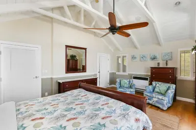 a bedroom with a bed and a ceiling fan at 821 West Bay Avenue in Newport Beach