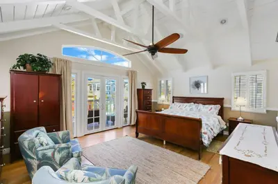 a bedroom with a bed and a ceiling fan at 821 West Bay Avenue in Newport Beach