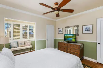 a bedroom with a bed and a ceiling fan at 821 West Bay Avenue in Newport Beach