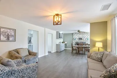 a living room with a couch and a dining room at Casa Rosé in Temecula