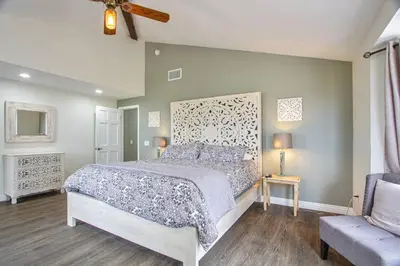 a bedroom with a large bed and a couch at Casa Rosé in Temecula