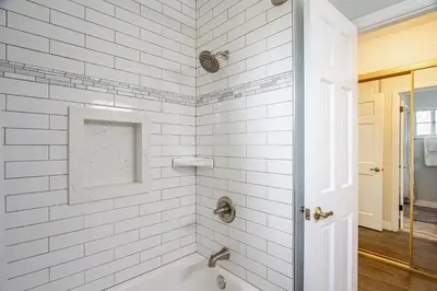a white bathroom with a tub and a sink at Casa Rosé in Temecula