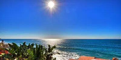a view of the ocean with the sun in the sky at Villa Bella Mare at the Retreat in Laguna Beach in Laguna Beach