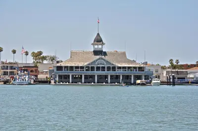 a large building with a clock tower on the water at 201 Ruby in Newport Beach