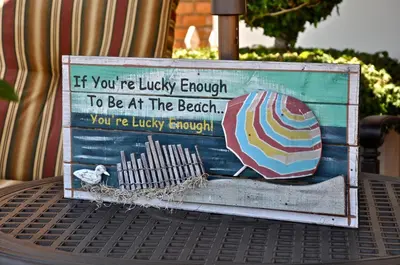 a sign on top of a table with an umbrella at 201 Ruby in Newport Beach