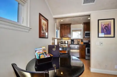 a kitchen with a black table and a dining room at Villa D'Arte at the Retreat in Laguna Beach in Laguna Beach