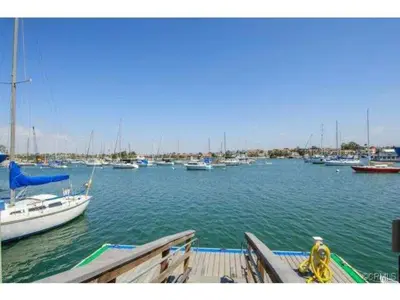 a bunch of boats are docked in a harbor at 313 E Bay Ave B in Newport Beach