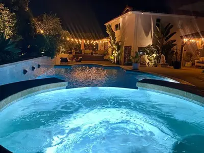 a large swimming pool in a backyard at night at Your Private Resort near Coast in Oceanside