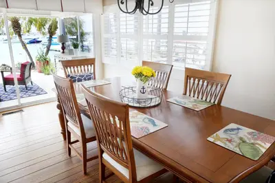 a dining room with a wooden table and chairs at 1400 S Bayfront in Newport Beach