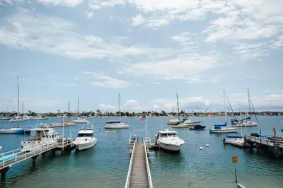 a bunch of boats are docked in the water at 1400 S Bayfront in Newport Beach