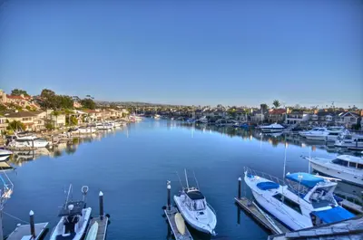 a group of boats are docked in a marina at 1005 E Balboa 2 in Newport Beach