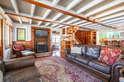 a living room with a leather couch and a fireplace at 318 Lindo Ave in Newport Beach