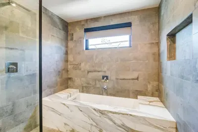a bathroom with a large tub and a window at 209 9th St in Newport Beach