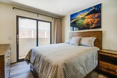 a bedroom with a large bed and a large window at 209 9th St in Newport Beach