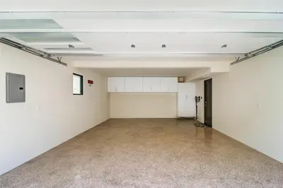 an empty room with white walls and a concrete floor at 209 9th St in Newport Beach
