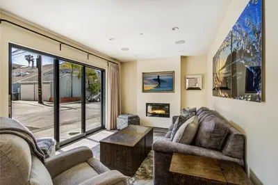 a living room with two couches and a fireplace at 209 9th St in Newport Beach
