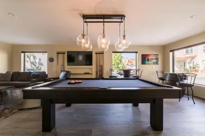 a pool table in the middle of a living room at 501 E Bay Ave in Newport Beach