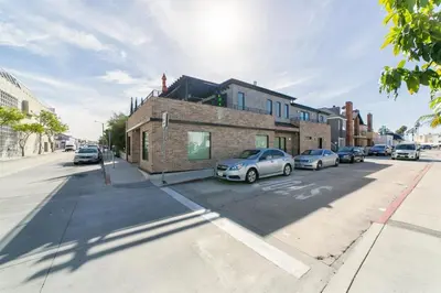 a street with cars parked in front of a building at 501 E Bay Ave in Newport Beach