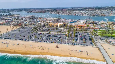 an aerial view of a beach with a crowd of people at 600 E Oceanfront 2B in Newport Beach