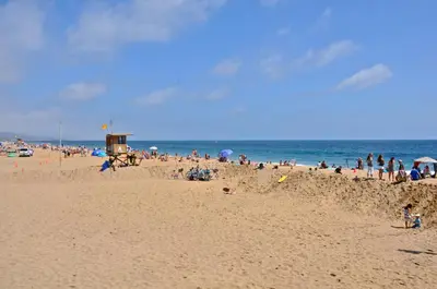 a beach with a lot of people playing in the sand at 600 E Oceanfront 2B in Newport Beach
